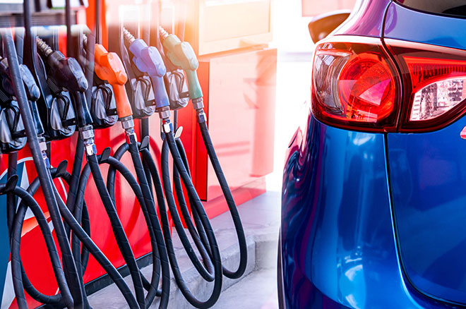 Blue luxury SUV car fueling at gas station. Refuel fill up with petrol gasoline. Petrol pump filling fuel nozzle in gas station. Petrol industry and service. Petrol price and oil crisis concept.